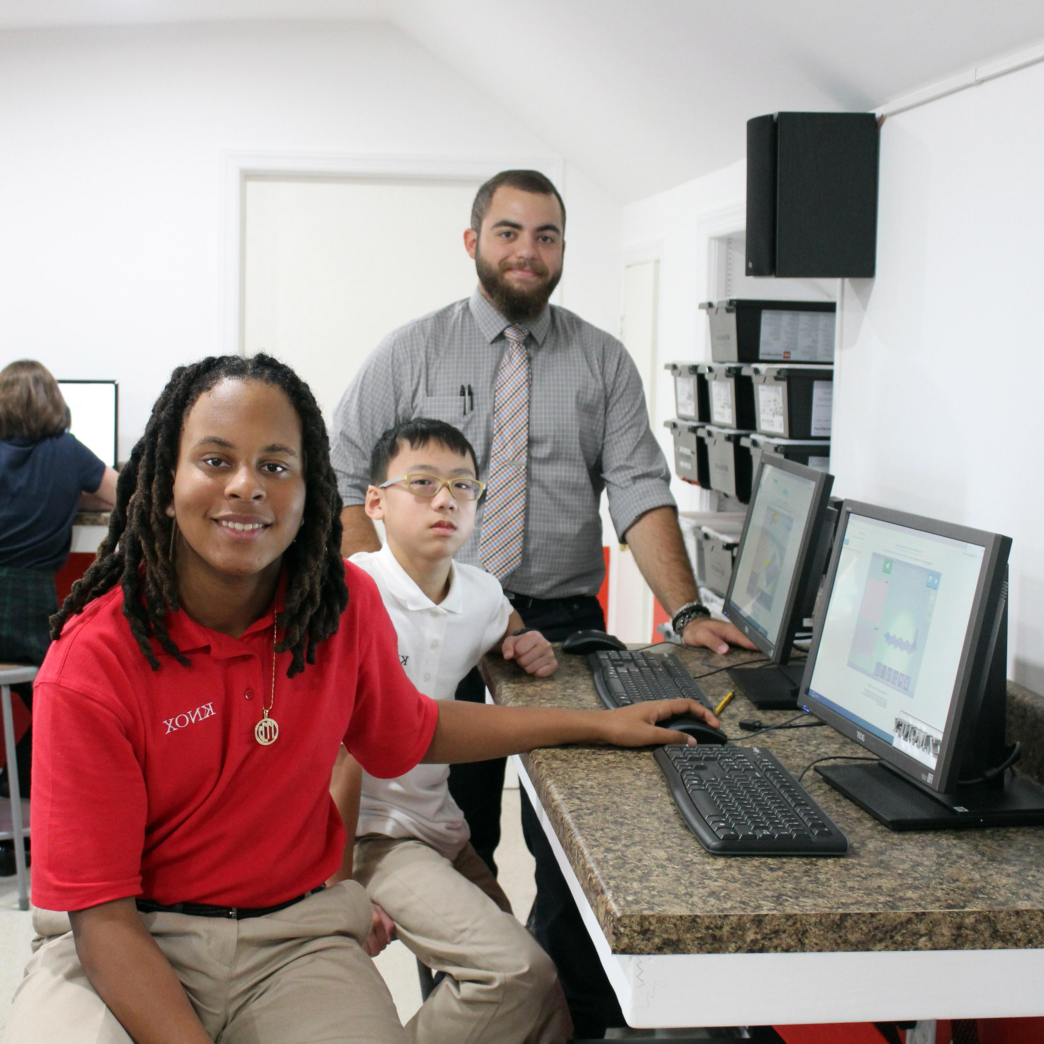 Image of STEM Teacher Angelo Mauro with two students